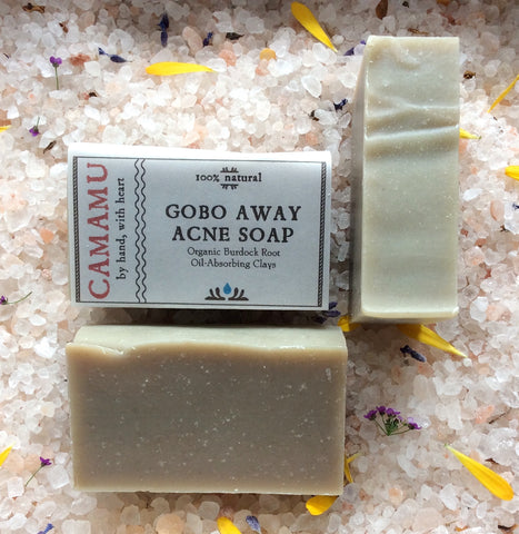 Camamu's GoBo Away Acne Soap is a complexion soap useful against acne-prone skin. Infused with organic burdock root and swirled with skin-conditioning clays, this soap is scented with anti-septic, skin-rebalancing essential oils.